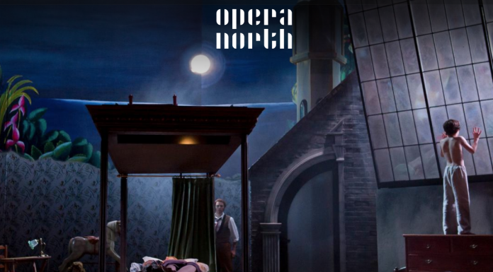 Susanna: Handel A theatrical scene with a moonlit backdrop, featuring an actor interacting near a bed.