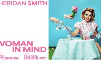 Sheridan Smith in Woman in Mind sitting at a table with a cup of trea and pink roses, dressed in a 1950's fashion style